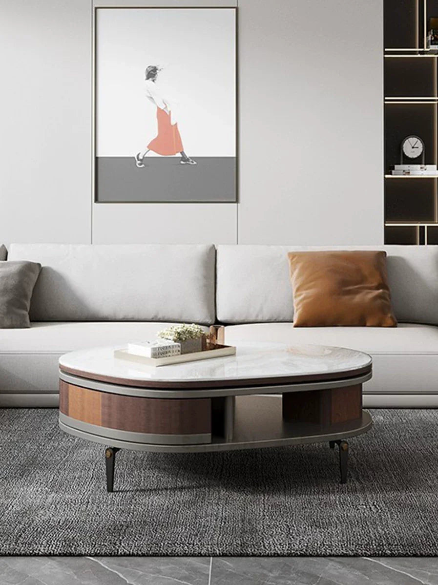 Modern living room with a gray sofa, round coffee table, and wall art.