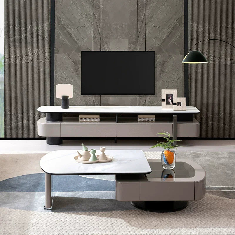 Modern living room with a television, coffee table, and decorative items.