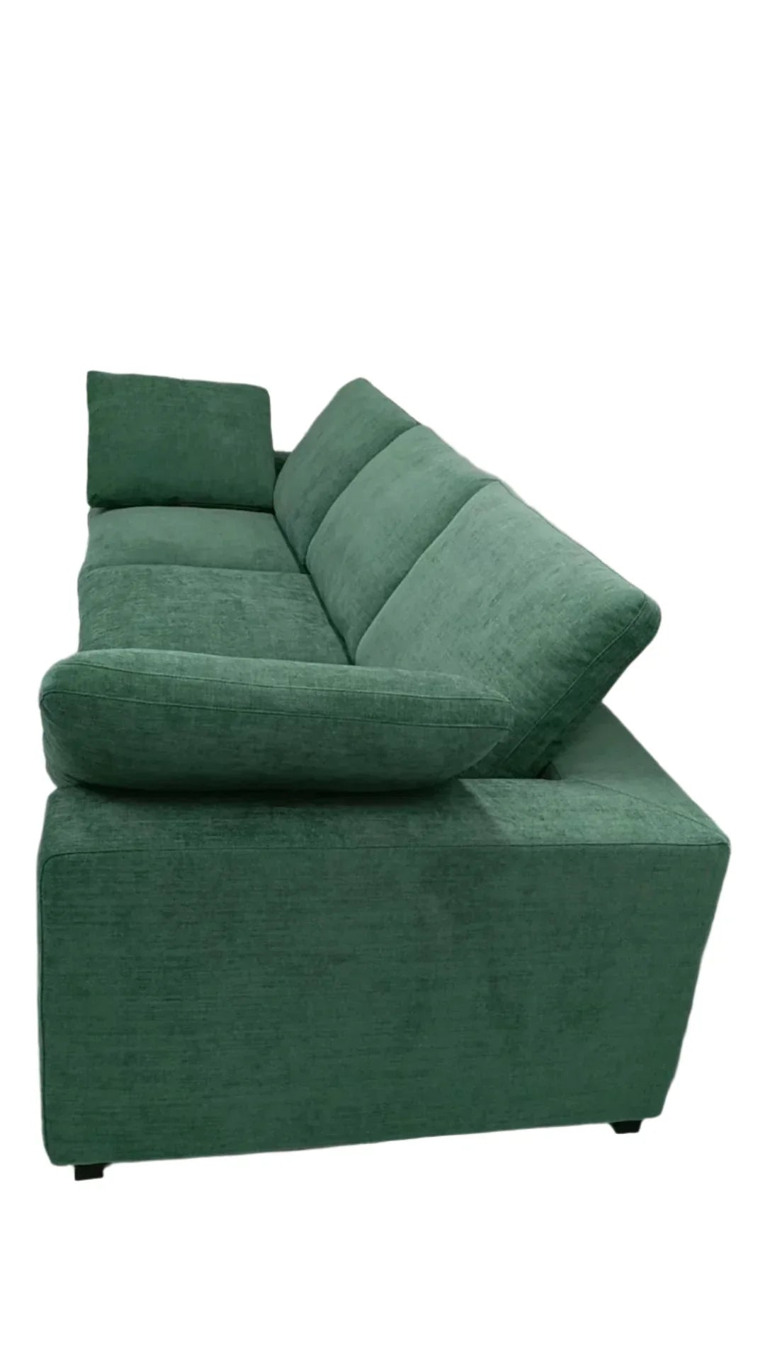 Green sectional sofa in a room with white walls and a light-colored floor.