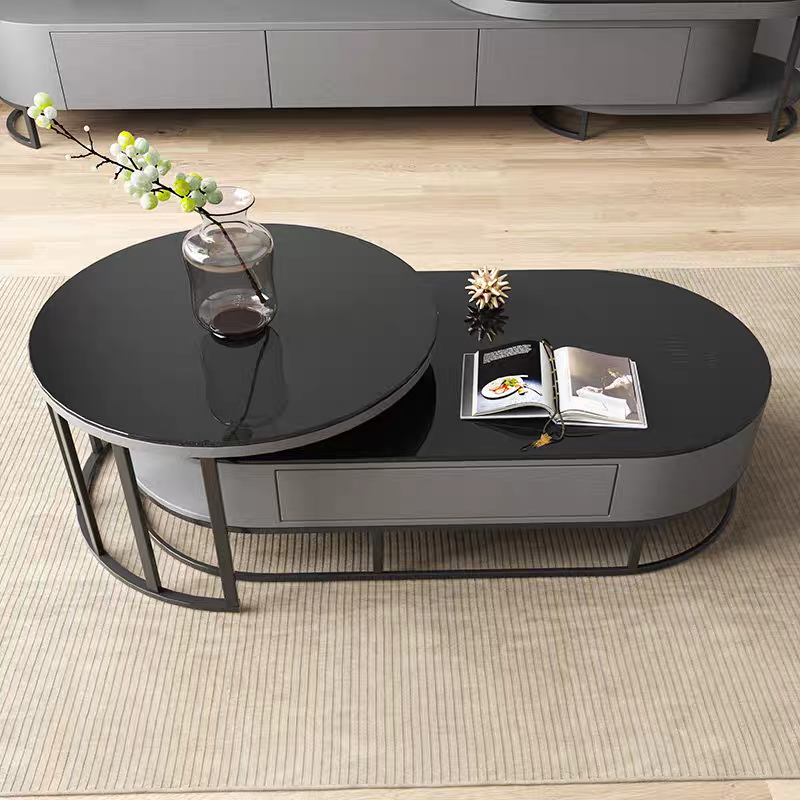 Modern black coffee table with decorative items on a wooden floor.