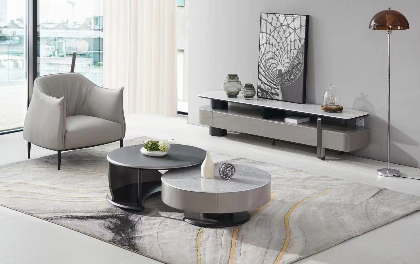Modern living room with gray armchair, coffee table, and TV stand.