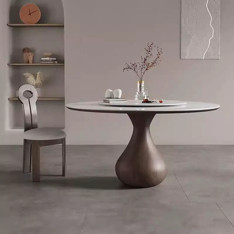 Dining room with a round table and chair against a gray wall.