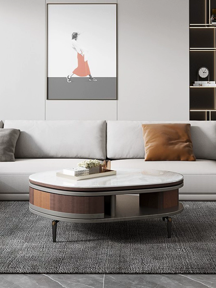 Modern living room with a gray sofa, round coffee table, and wall art.