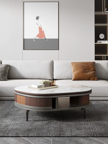 Modern living room with a gray sofa, round coffee table, and wall art.