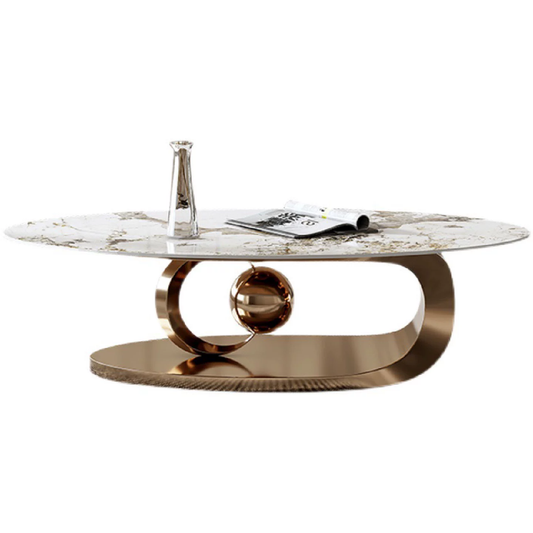 Aurora Luxe oval marble coffee table with rose gold base and central metallic sphere, styled in a modern glam living room.