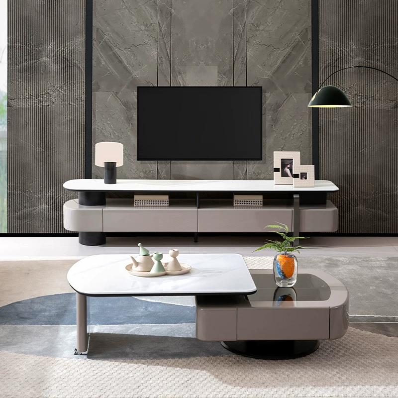 Modern living room with a television, coffee table, and decorative items.
