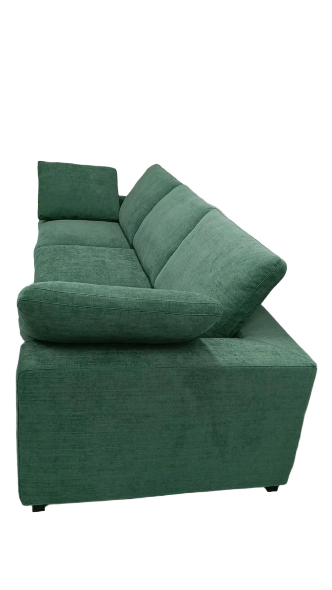 Green sectional sofa in a room with white walls and a light-colored floor.