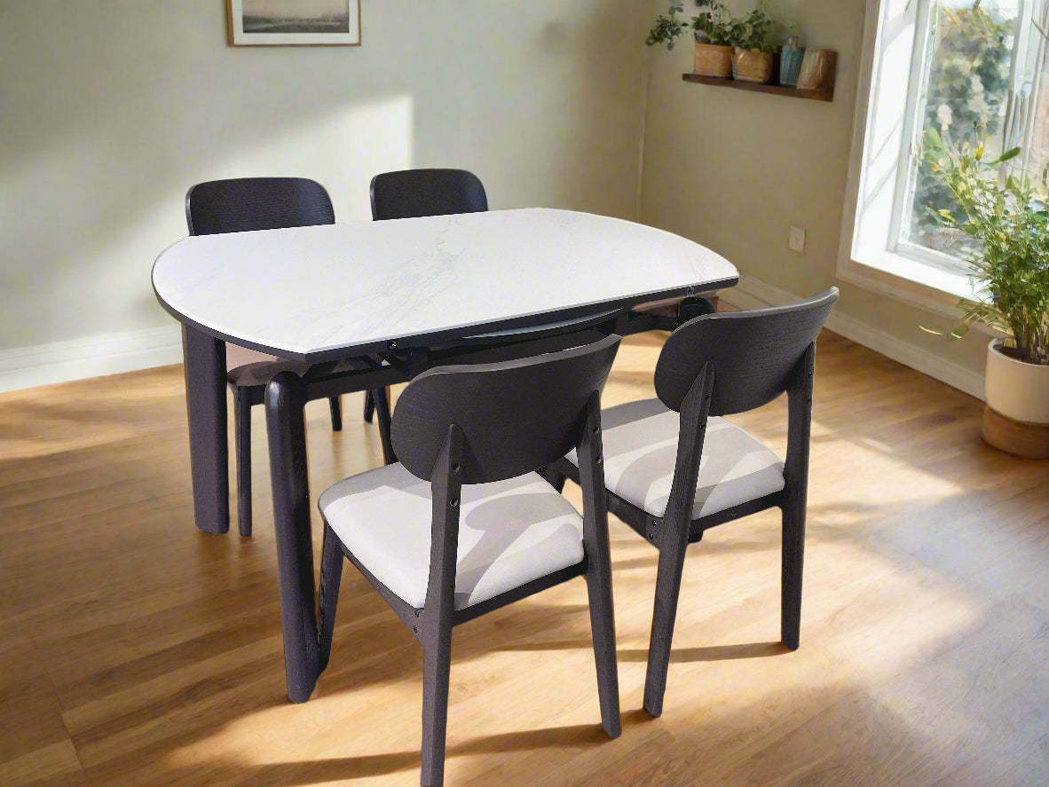 Dining table with four chairs in a room setting
