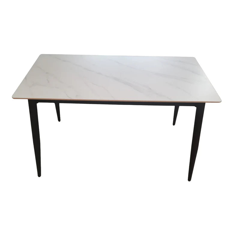 Angled view of minimalist 120cm marble-look dining table with matte white finish and black legs