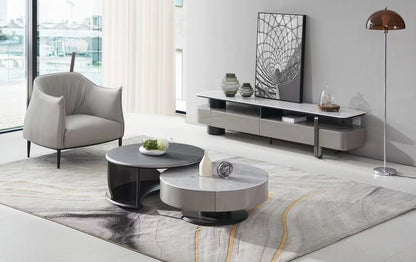 Modern living room with gray armchair, coffee table, and TV stand.