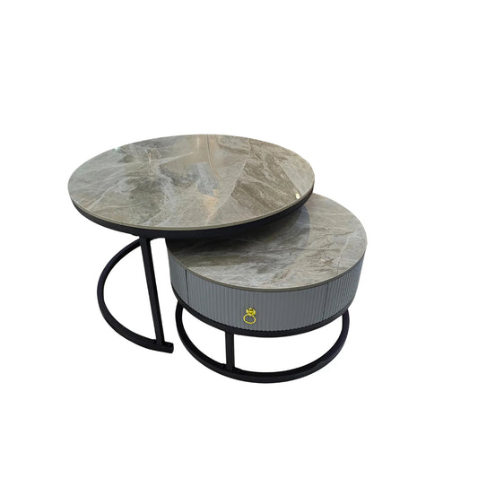 Set of two round marble coffee tables with black metal legs on a white background
