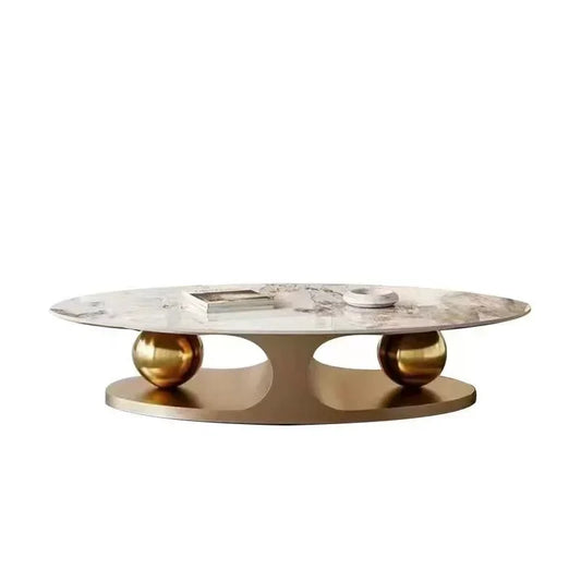 Marble coffee table with gold spherical bases on a white background