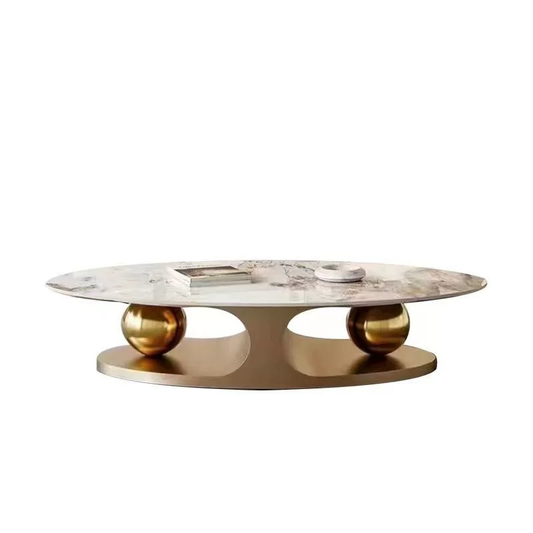 Marble coffee table with gold spherical bases on a white background