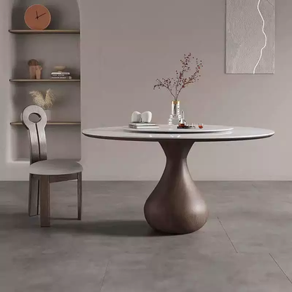 Dining room with a round table and chair against a gray wall.