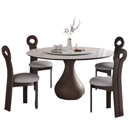 Round dining table with four matching chairs on a white background