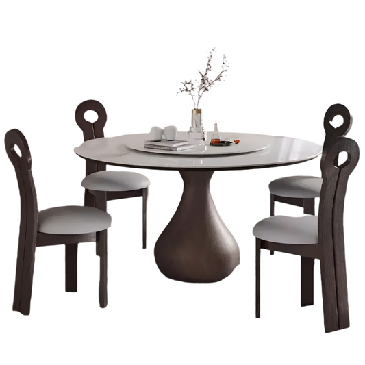 Round dining table with four matching chairs on a white background