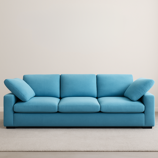 Blue sofa with cushions on a plain background