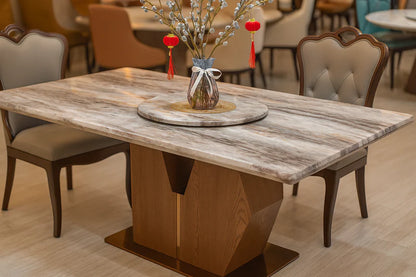 Angled view of luxury super-crystalline marble dining table featuring rounded polished edges and geometric V-shaped base